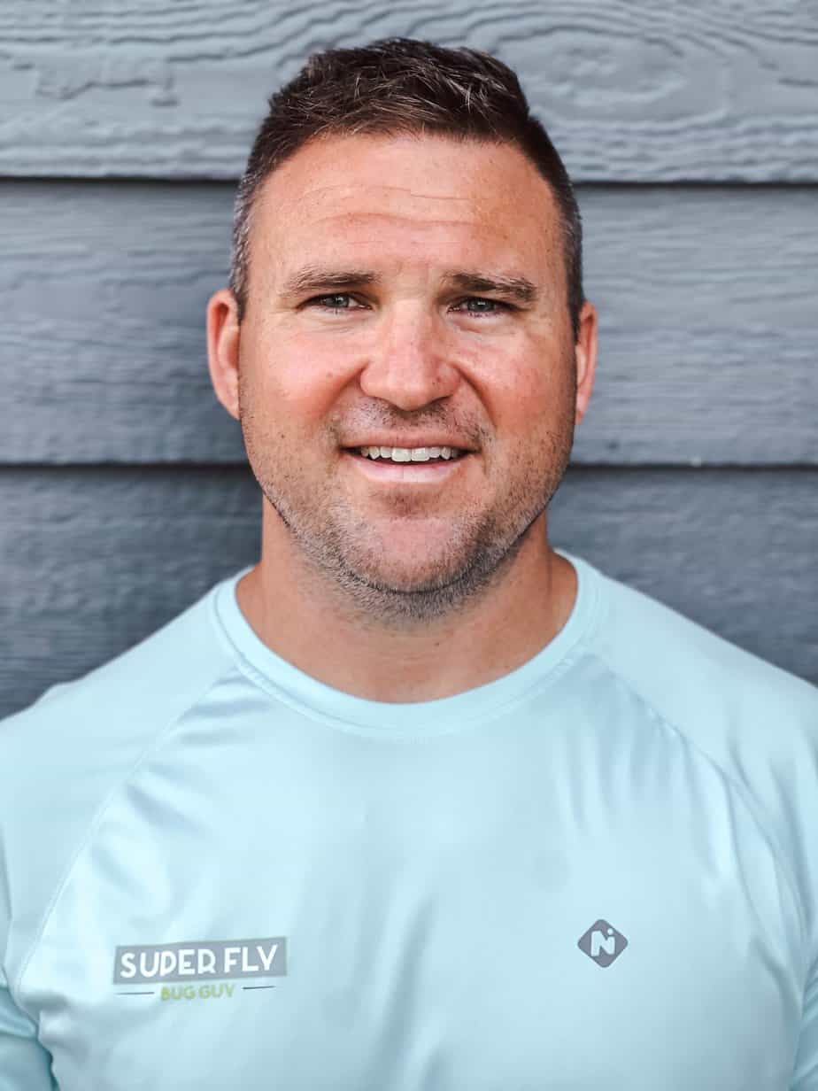 A man wearing a blue shirt with the word superfly on it.